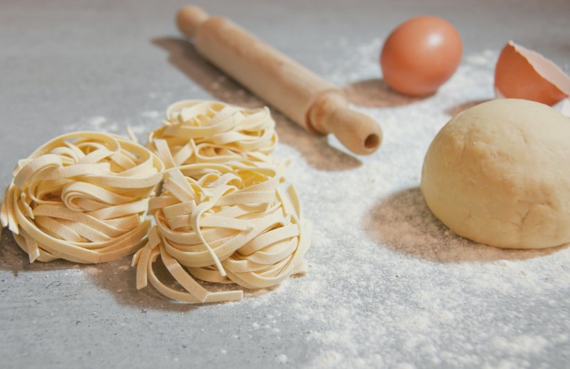 Homemade italian pasta on a grey table.