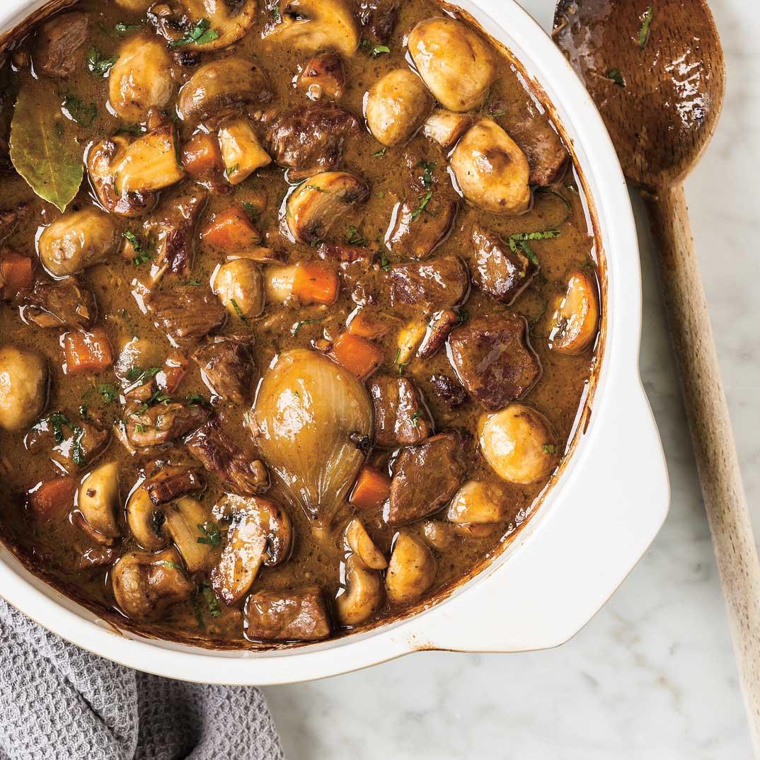 Beef bourguignon in a white casserole dish