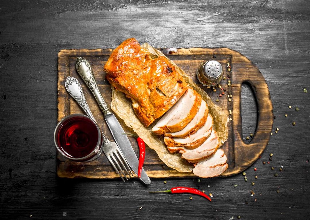 Pork filet mignon in red wine sauce with seasonings served on an old wooden table