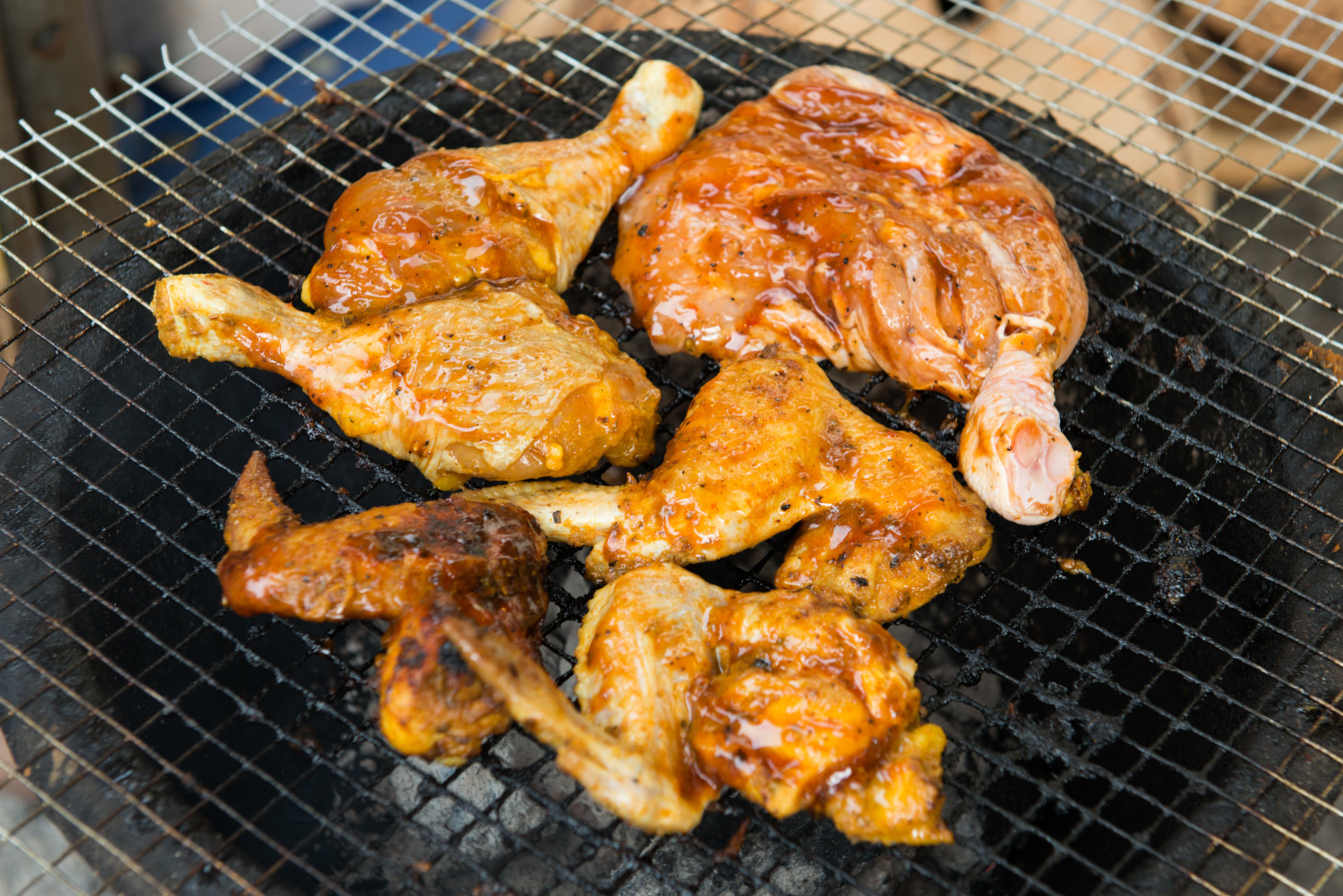 BBQ chicken meat roasted on hot flaming charcoal grill