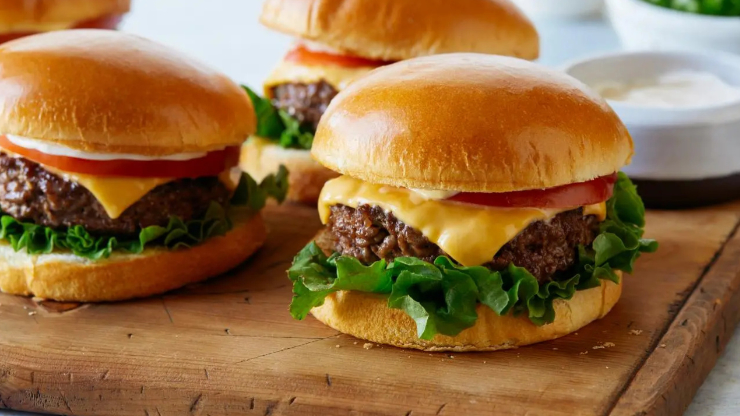 wooden slate with 3 hamburgers